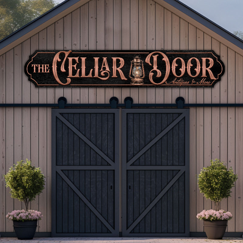 Metal business sign, copper lettering on black sign, above barn door.
