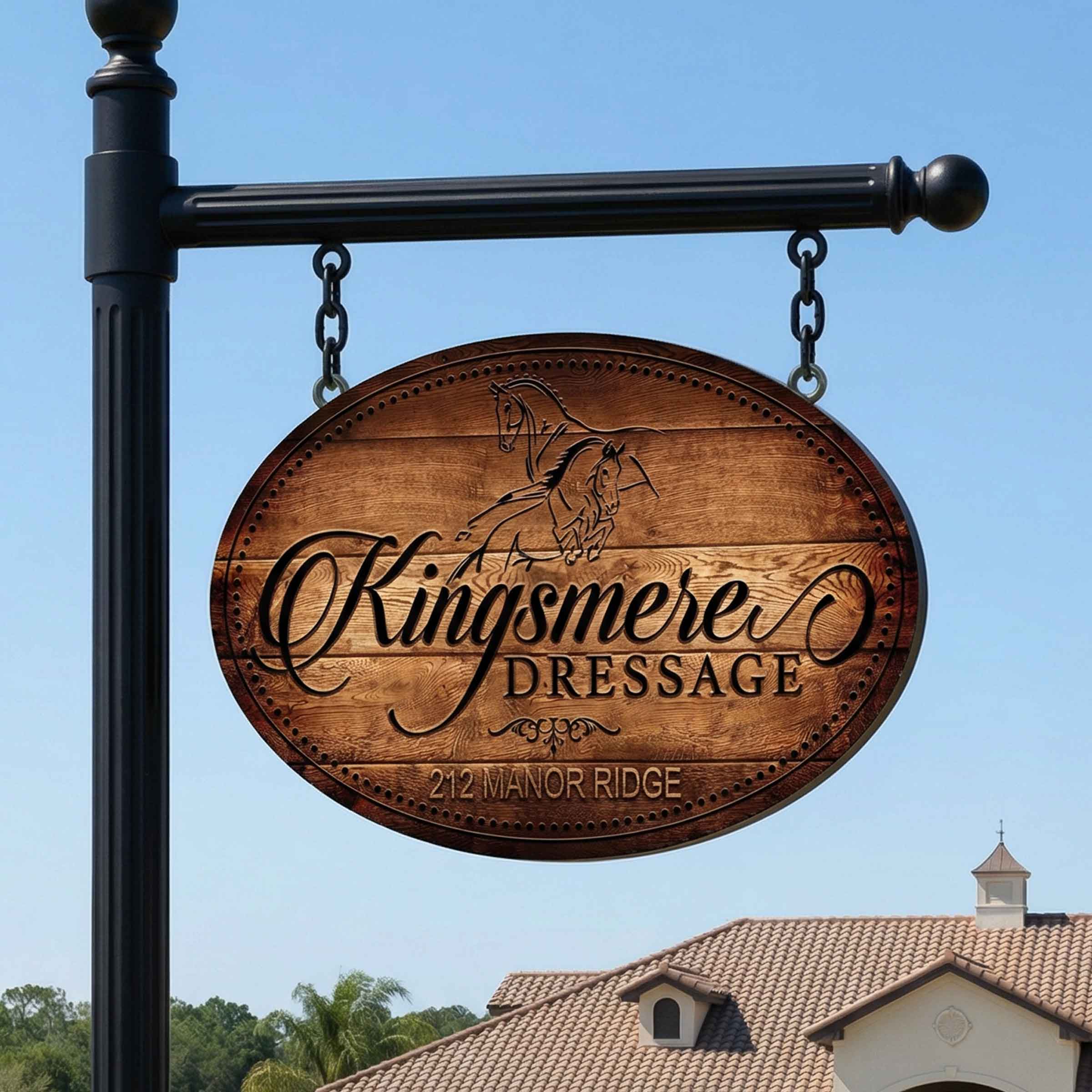 Wooden metal horse sign for Kingsmere Dressage against a clear blue sky