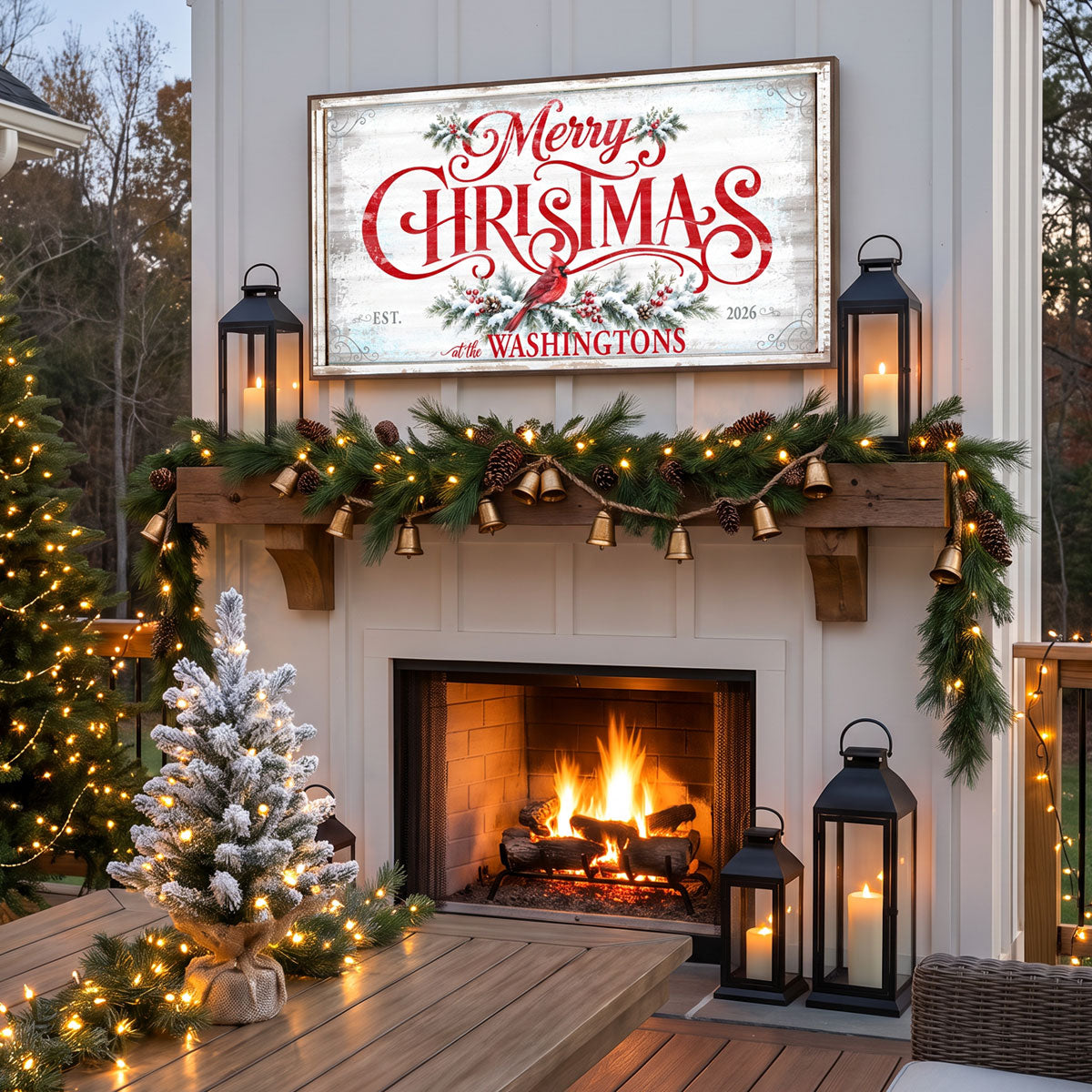 Metal Merry Christmas sign above an outdoor patio fireplace at dusk with lanterns, garland and brass bells