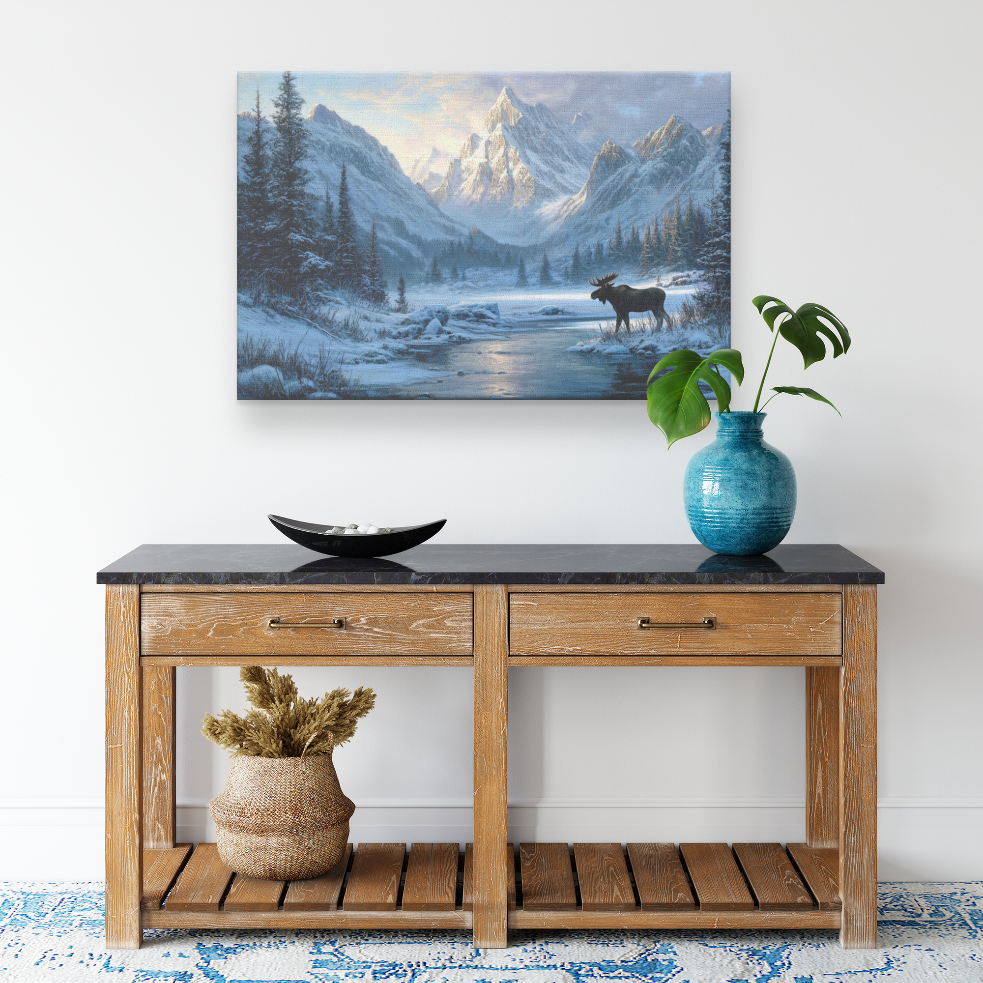 moose canvas art print of a lone moose standing by a frozen alpine lake with snowy pines and mountains at sunrise