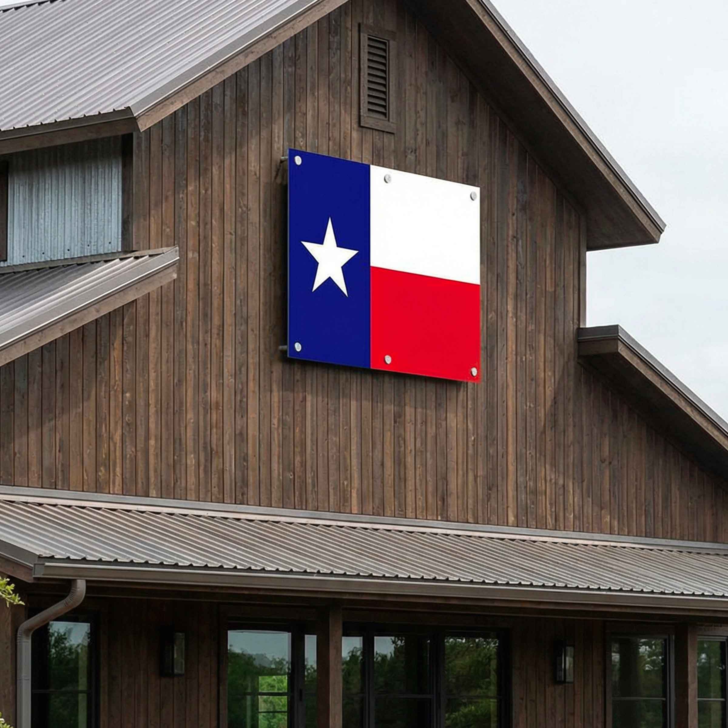 Texas state flag mounted on the exterior wooden wall of a rustic cabin-style building.