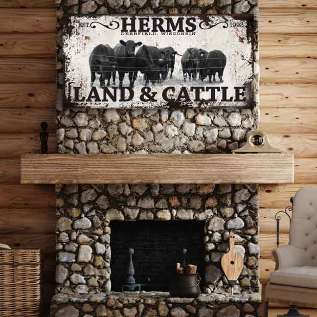 personalized cattle ranch sign with family name and black angus cows by the fence.
