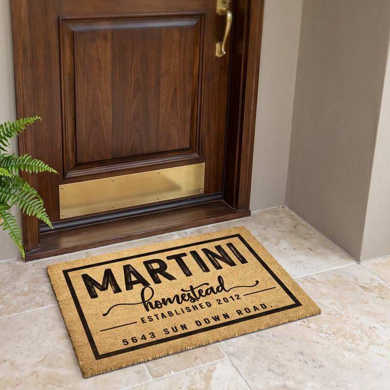 Personalized door mat with address on natural coir at a walnut door with a brass kickplate