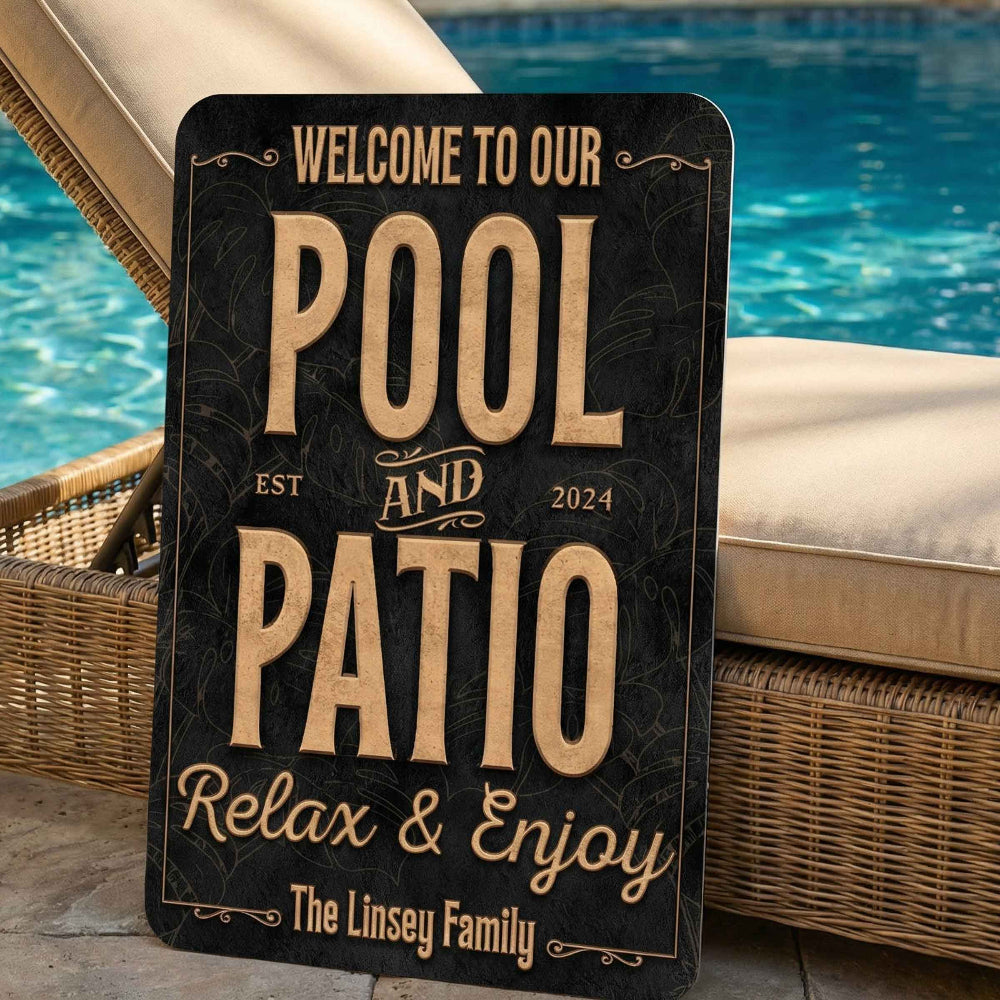 Personalized pool deck sign leaning up on a lounge chair that says Pool and Patio