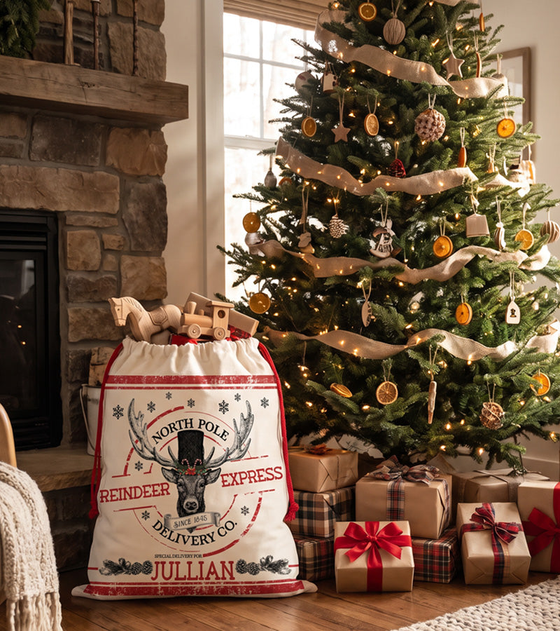 Large personalized Santa sack printed with a vintage engraved reindeer, filled with wrapped gifts