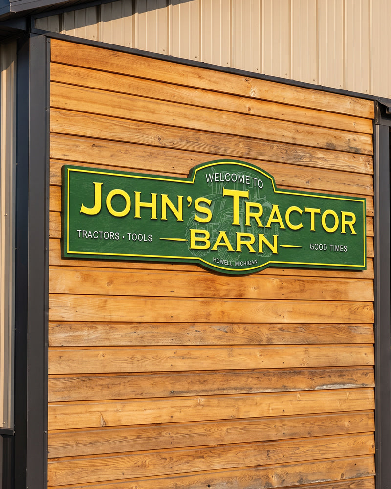 Personalized tractor barn sign in green and yellow mounted on a cedar plank pole barn wall