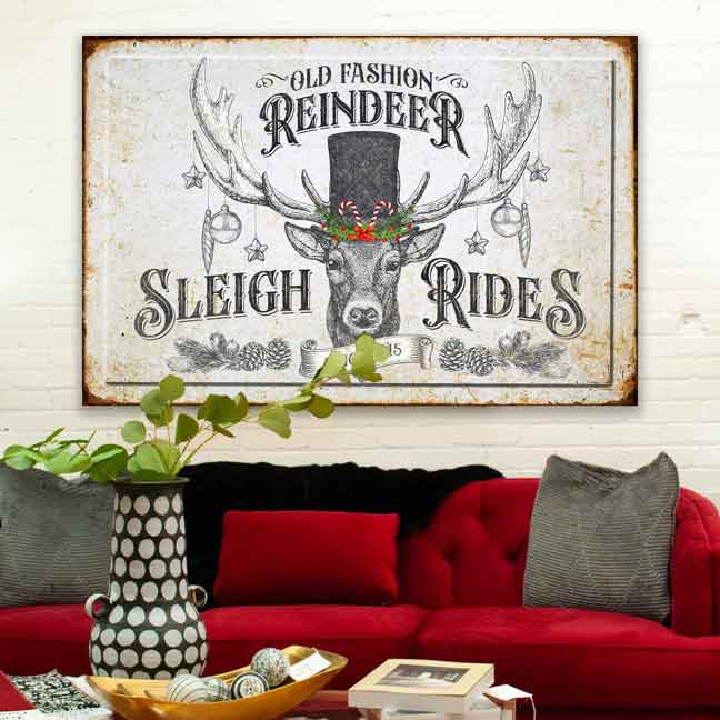 Christmas wall art of a old fashion reindeer sleigh rides with deer in black top hat and ornaments hanging.