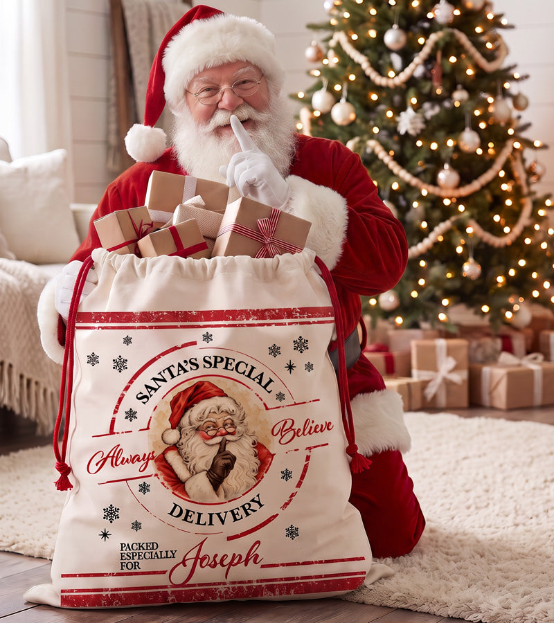 Santa's Special Delivery sack with a painted Santa Claus keeping the secret, beside a Christmas tree