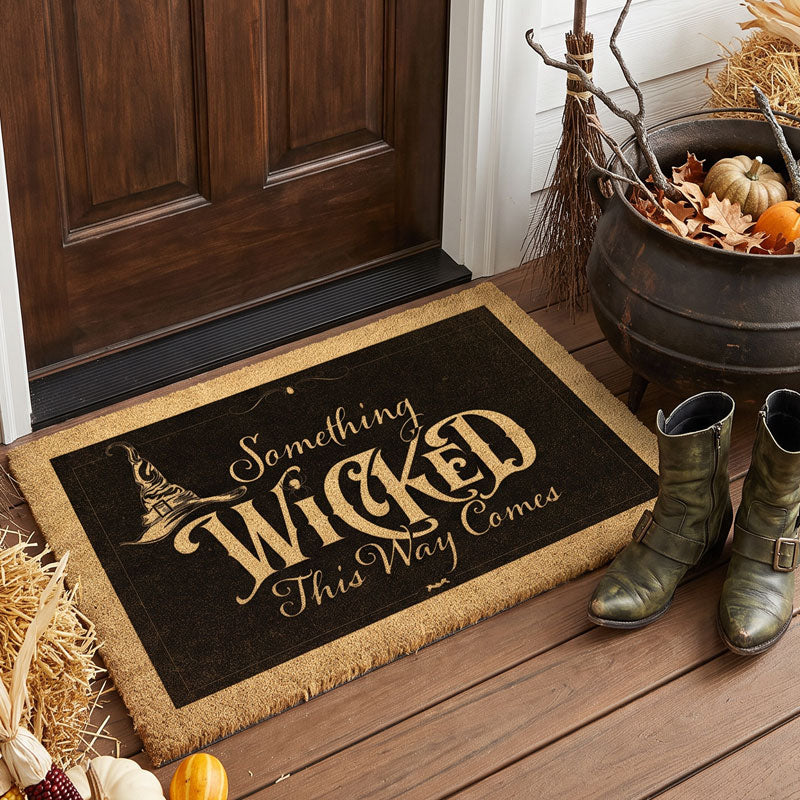 Something Wicked This Way Comes doormat in gold on black with a witch hat, by a cauldron and boots