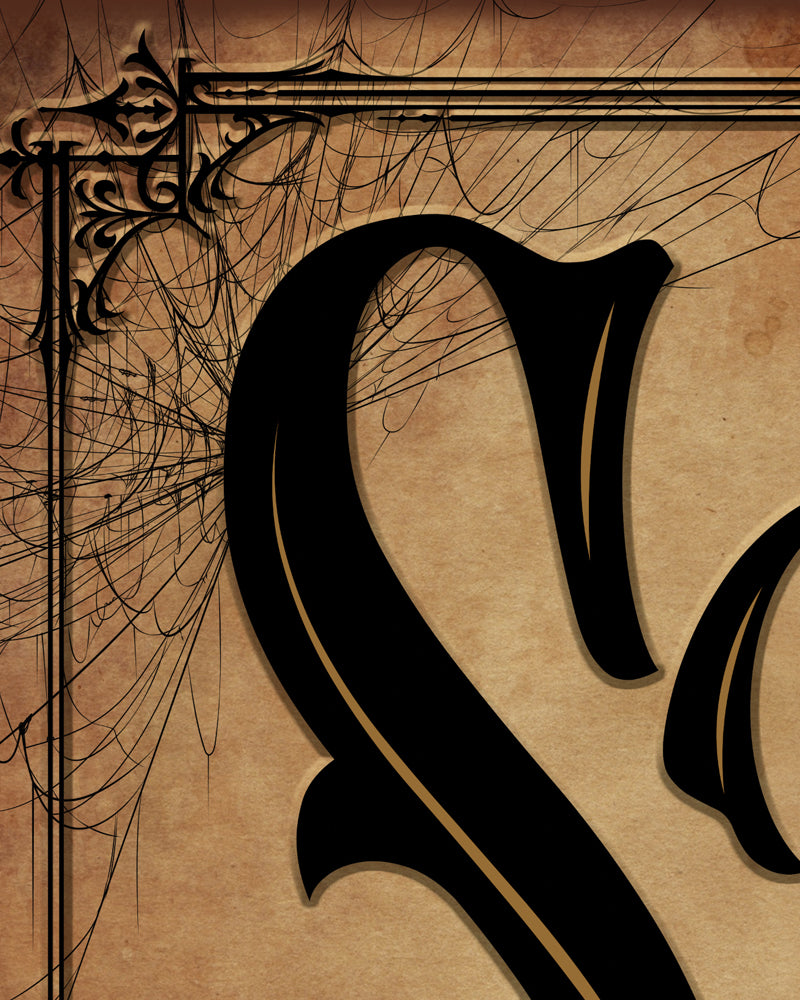 Closeup of the Spookeasy sign gothic lettering with gold pinstripe, filigree corner and cobwebs on aged parchment