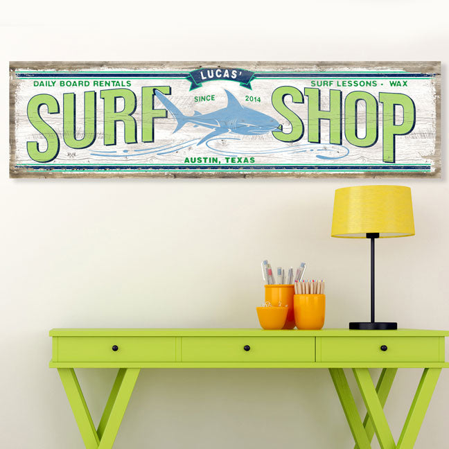 shark surf board art with worn wood and a shark on front with green letters