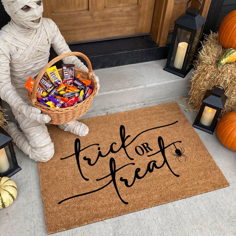 Trick or Treat halloween door mat with mummy holding candy basket at front door with pumpkins