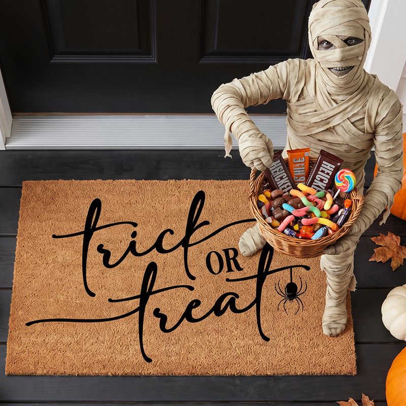 Trick or Treat halloween door mat overhead with mummy holding candy basket and pumpkins
