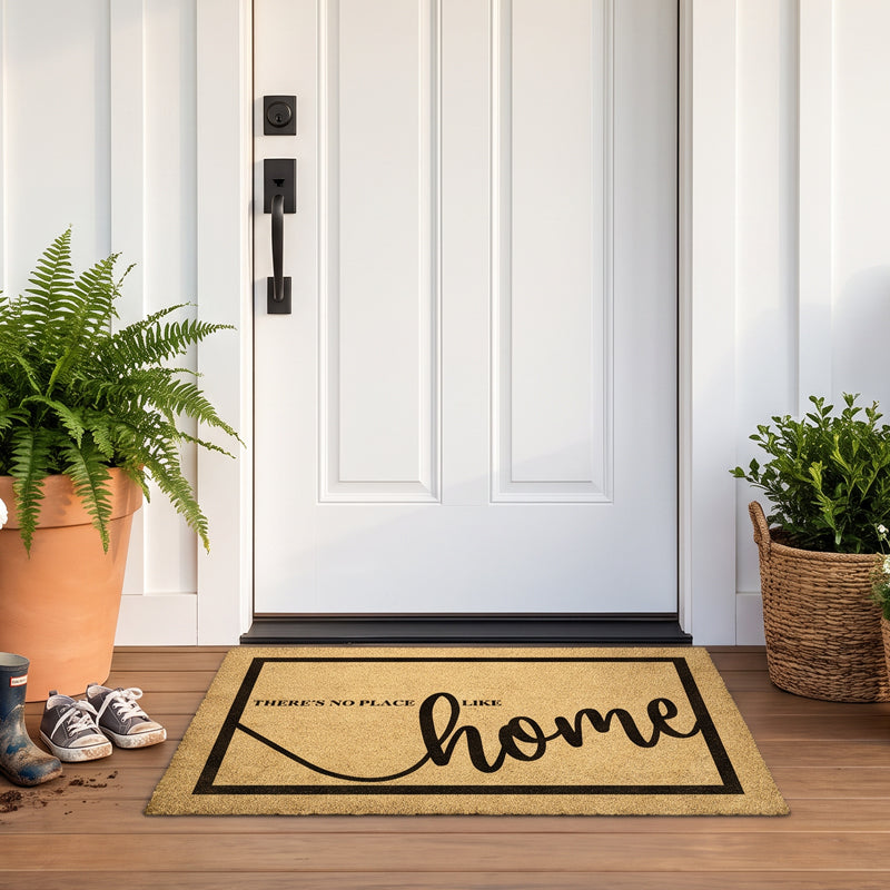 There's No Place Like Home mat at a white door with a fern, boots and a boxwood basket