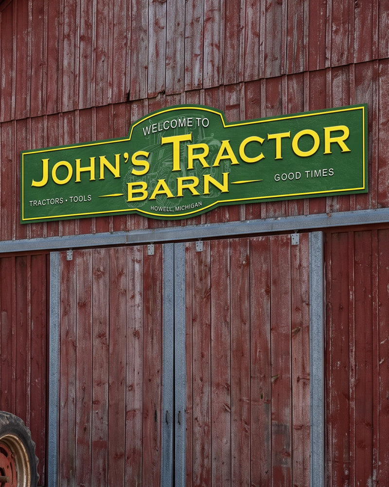 Tractor barn sign in green and yellow mounted above the doors of a weathered red barn