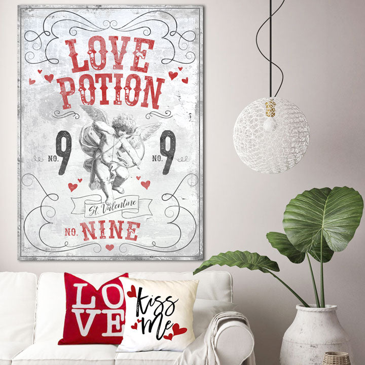 Valentines Day decor sign on white distressed wood with Cupid and the words [love potion no. 9 St. Valentine] with red valentine hearts