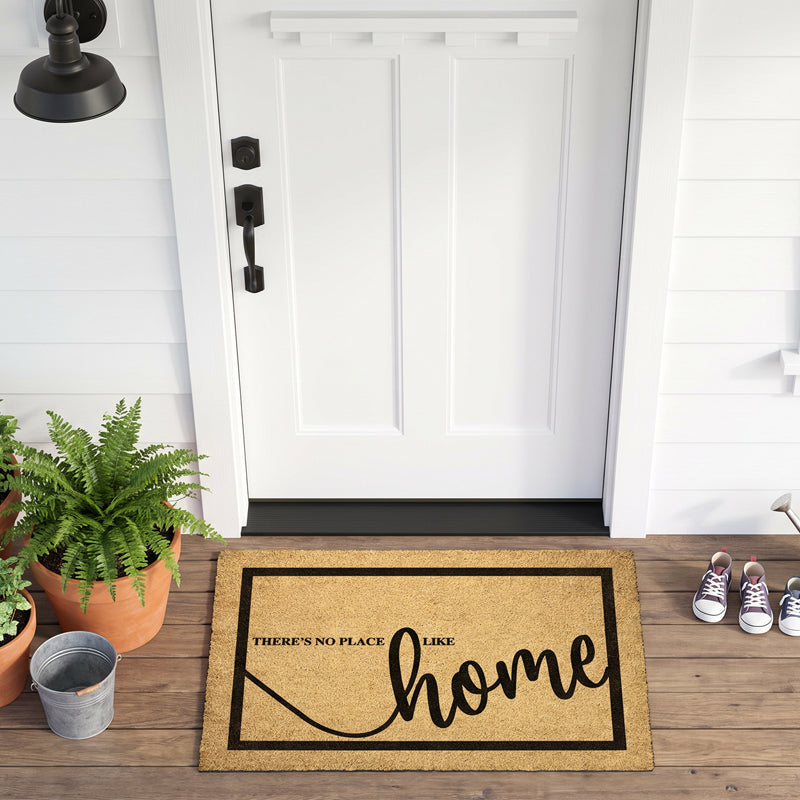 Welcome home doormat on a farmhouse porch with a fern, galvanized bucket and sneakers
