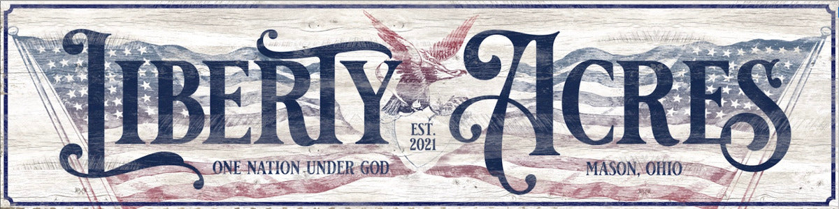 Large barn sign in red, white and blue displaying the American Flag with and eagle.