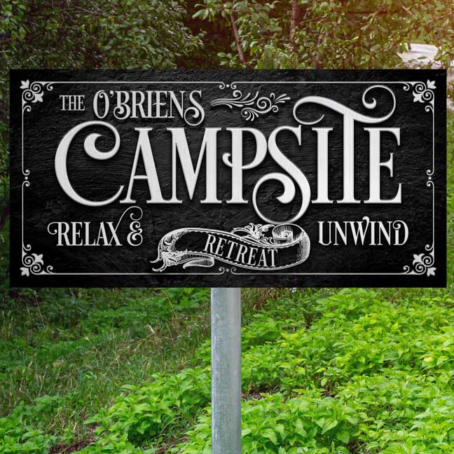 Camping Sign - Family Camp Sign made of black textured metal with Silver words that say: family name campsite relax and unwind