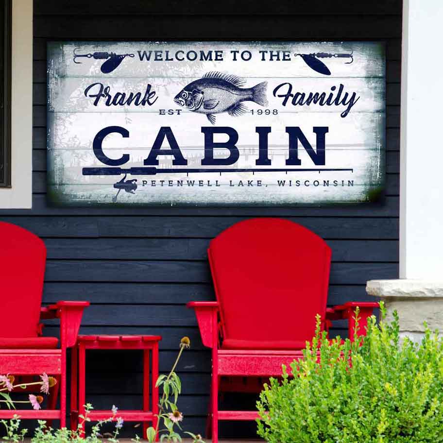 Lake house sign with the words [welcome to the 'family' name Cabin, with city and state. with a sunfish and fishing pole.