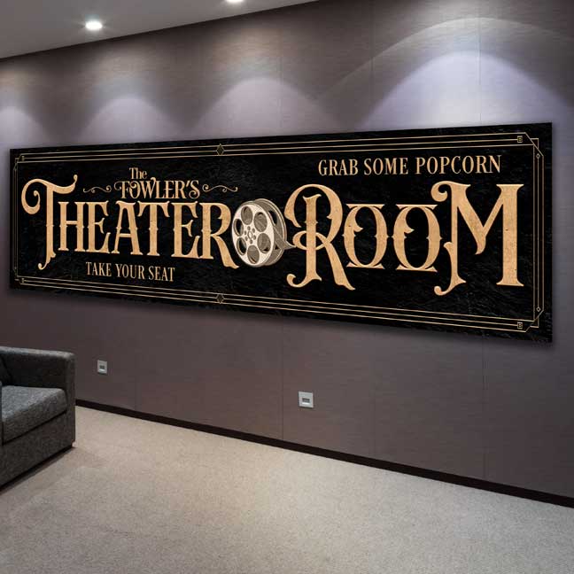 Tailor Made Rooms Theater Room Sign in Gold lettering on black textured background, with a movie reel and family name