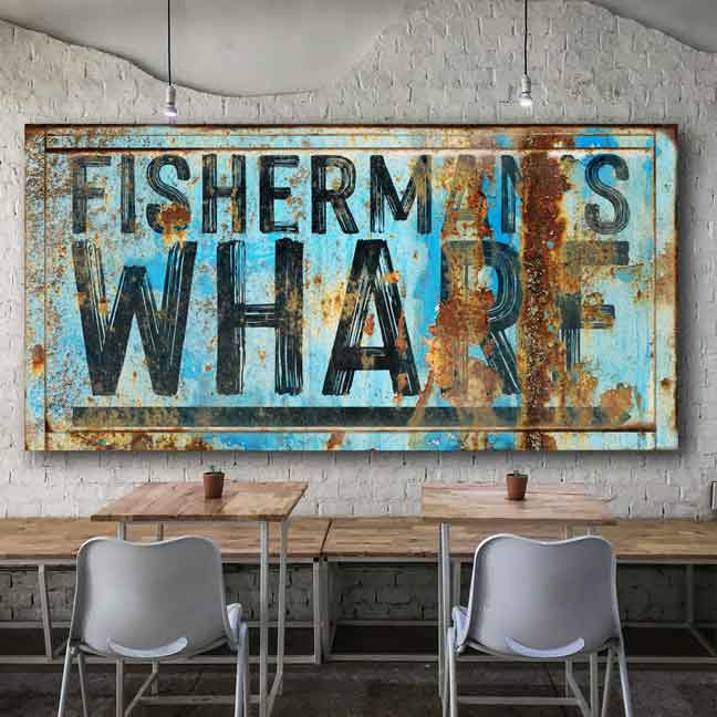 Coastal wall  Decor, restaurant decor of distress blue rusty metal sign with the words: Fisherman's Wharf with an arrow.