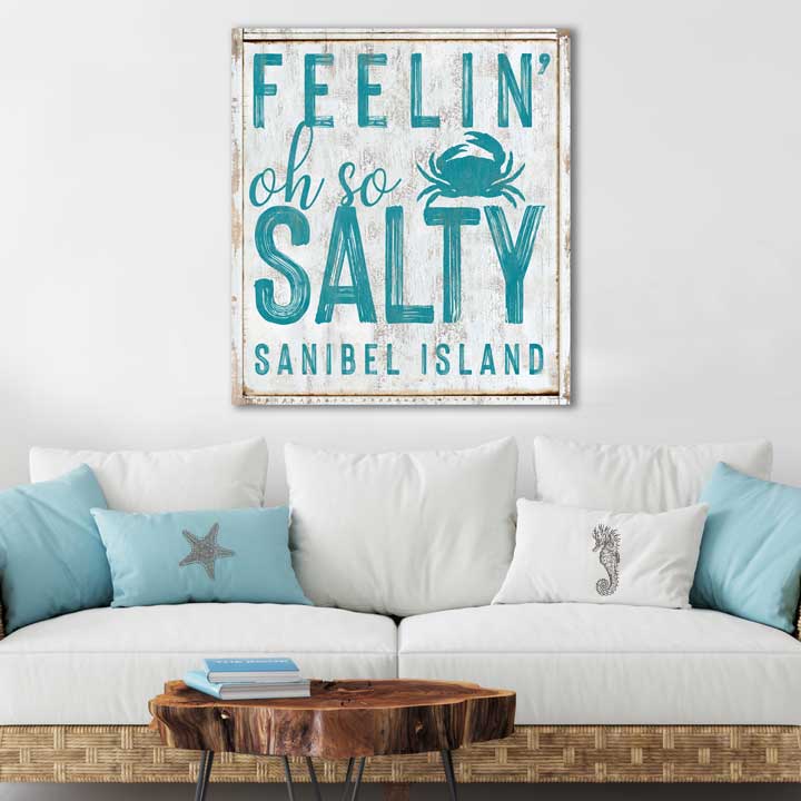 Beach house decor sign of a chippy painted sign with the words [feelin' oh so Salty, Sanibel Island]